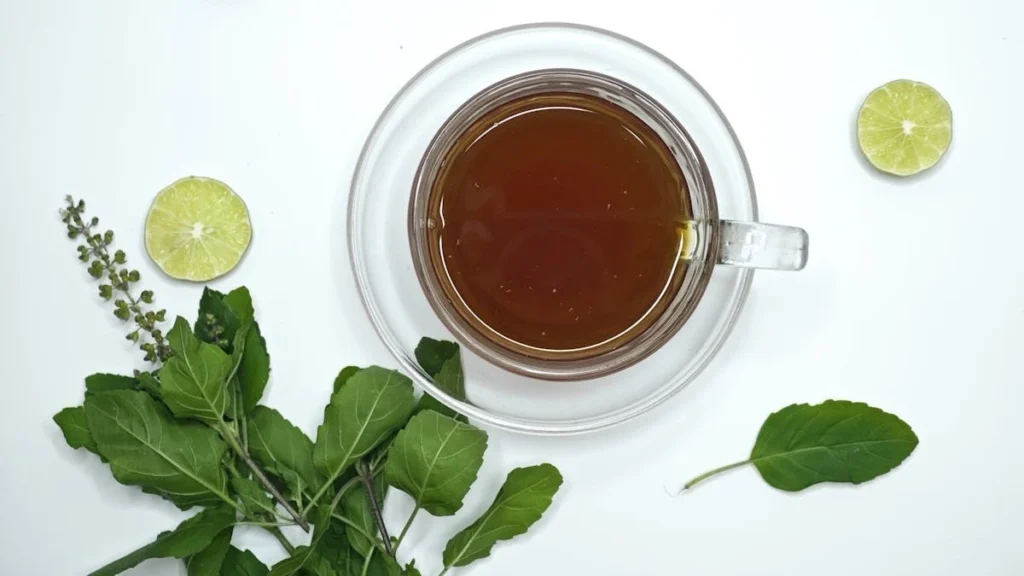 Green tea leaves and cup evaluating possible liver damage from overuse.