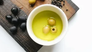 Bottle of olive oil and fresh olives.