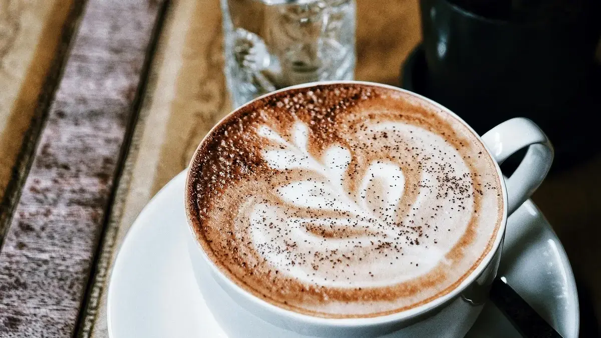 Cup of coffee next to a liver icon representing coffee’s impact on liver health.