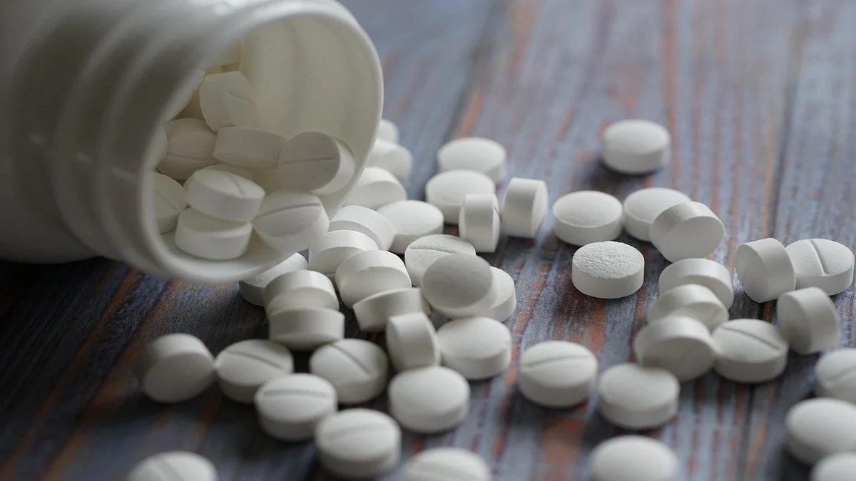 Array of calcium supplement tablets on wooden table