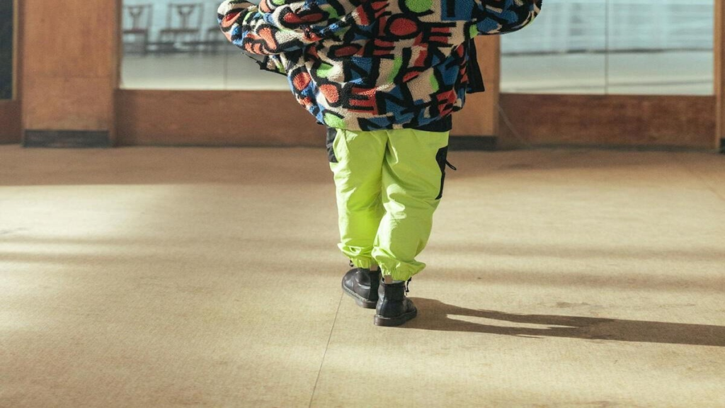 Person walking backwards on a path, showing reverse gait posture.