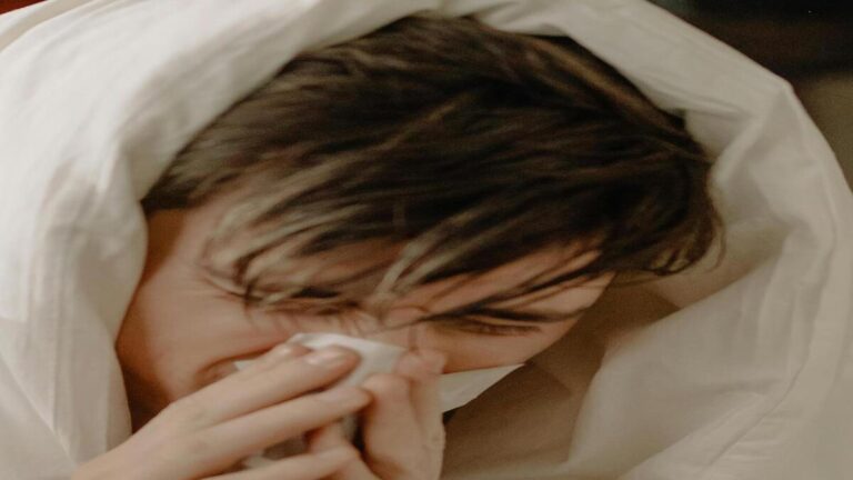 Cup of herbal tea with ginger and honey on wooden table for cold and flu relief