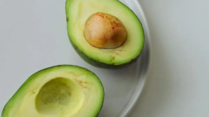 Avocado fruit on cutting board showing heart-healthy nutrients like healthy fats, potassium, and fiber
