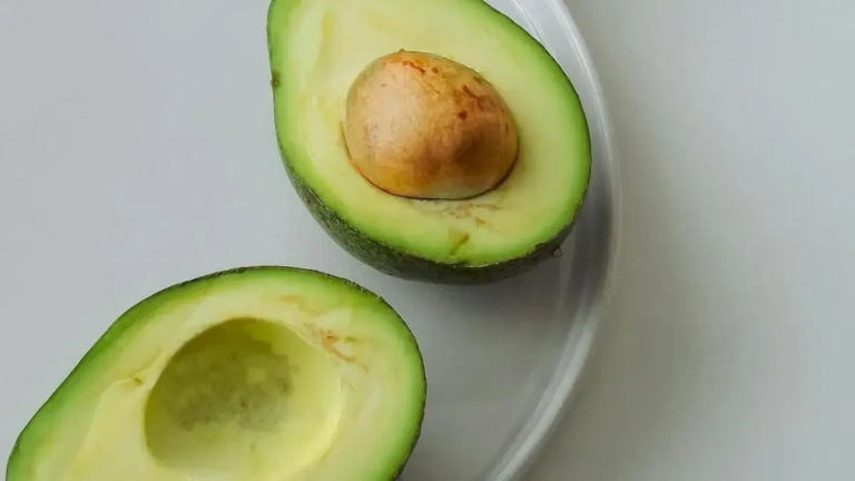 Avocado fruit on cutting board showing heart-healthy nutrients like healthy fats, potassium, and fiber