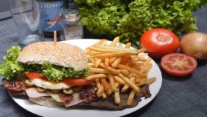 Variety of collagen‑boosting foods and drinks (chicken, fish, fruits, leafy greens, bone broth) on a table.