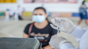 Metformin pills on a table with Long COVID concept in the background