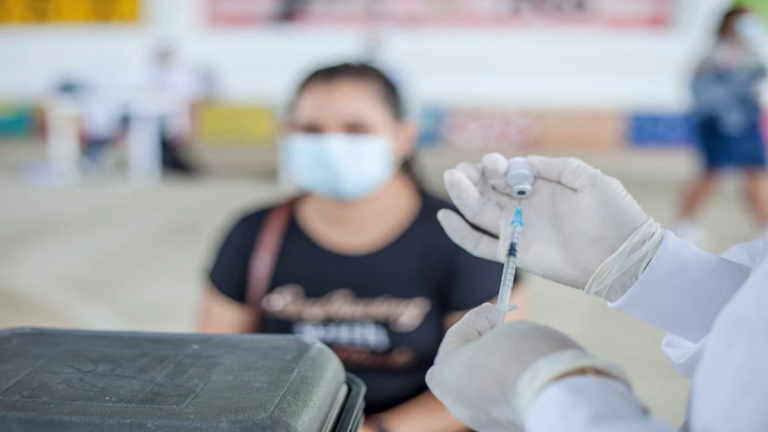 Metformin pills on a table with Long COVID concept in the background