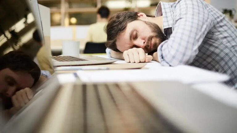 Person resting in a quiet room taking a short midday nap for health benefits.