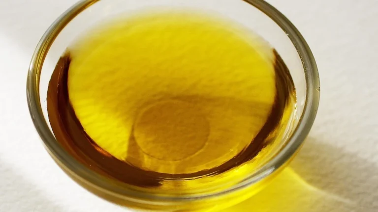 Extra virgin olive oil in glass bottle with fresh olives for diabetes friendly cooking