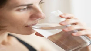 Person drinking warm water for digestive comfort and hydration