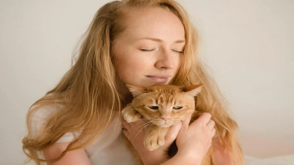 Cat owner practicing safe litter box hygiene to reduce toxoplasmosis risk
