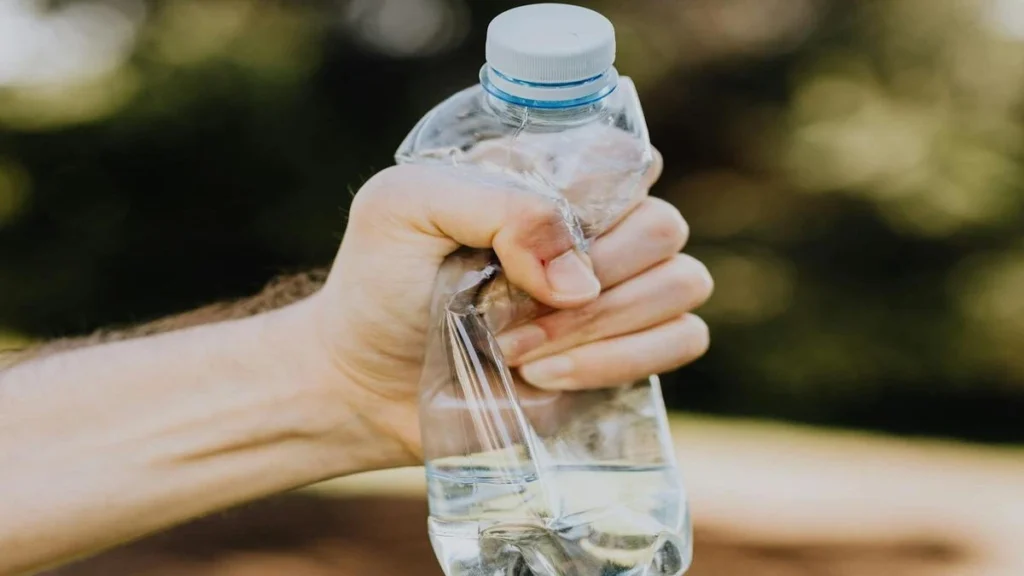 Plastic water bottle and heart health concept showing microplastics risk and cardiovascular disease link