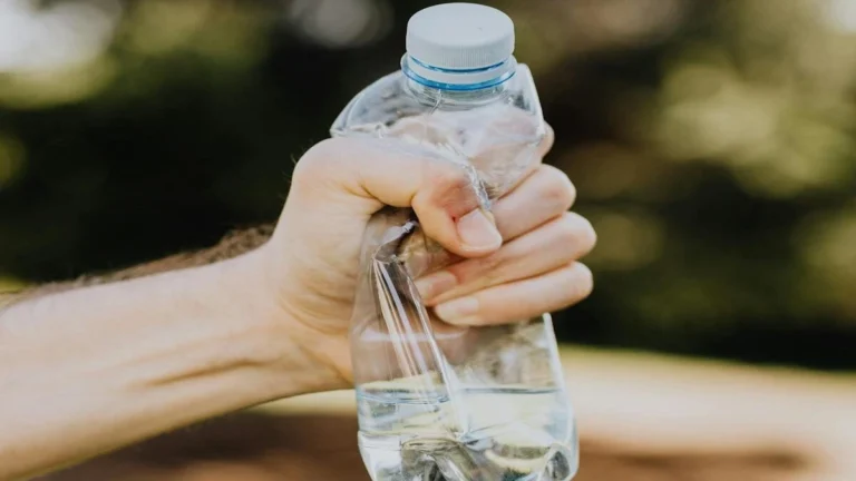 Plastic water bottle and heart health concept showing microplastics risk and cardiovascular disease link