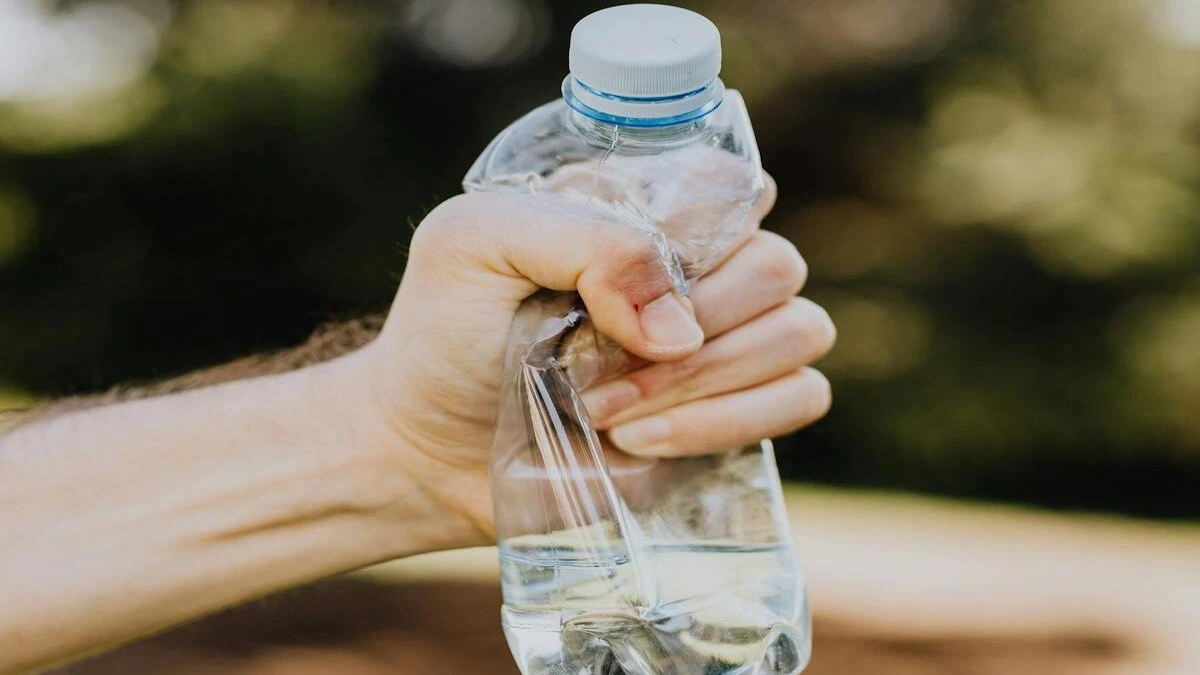 Plastic water bottle and heart health concept showing microplastics risk and cardiovascular disease link