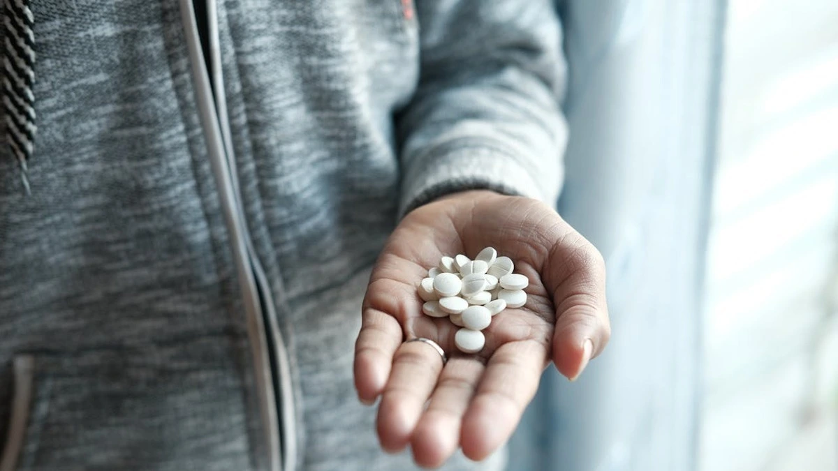 Doctor discussing medications and sexual health concerns with male patient in clinic