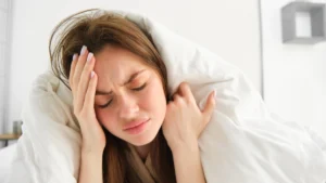 Woman lying awake in bed struggling with insomnia at night