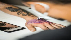 Tattoo needle injecting ink into skin triggering immune response