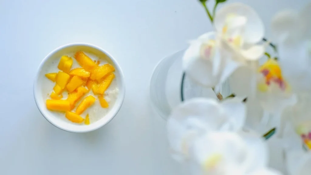 Mango cubes mixed with plain yogurt in a bowl for a healthy diabetes-friendly snack