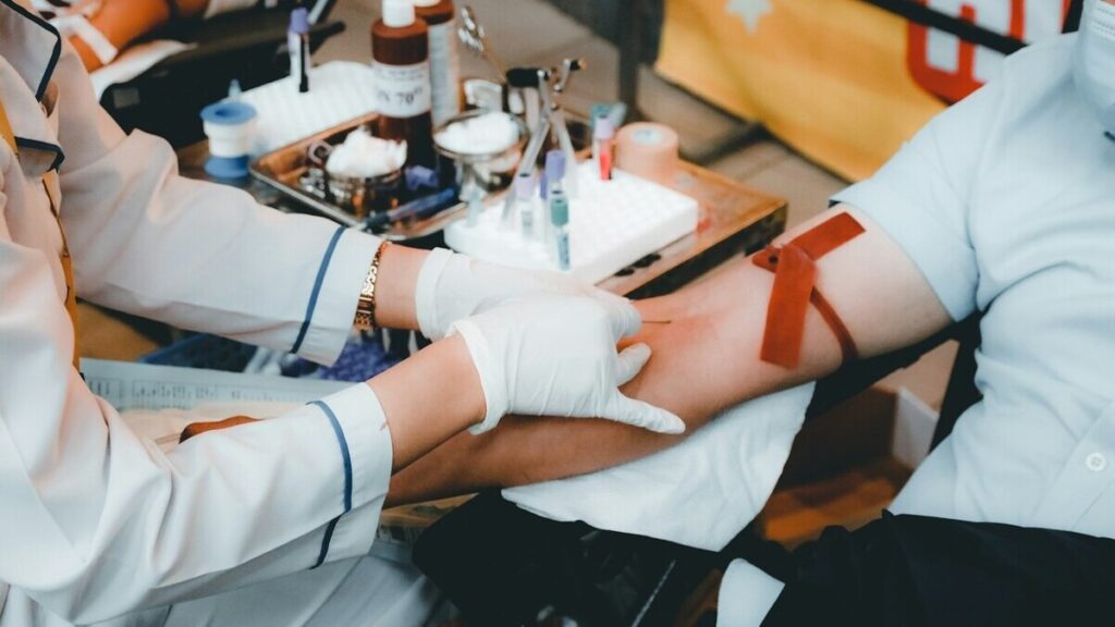 Doctor reviewing blood test report showing HbA1c and glucose levels