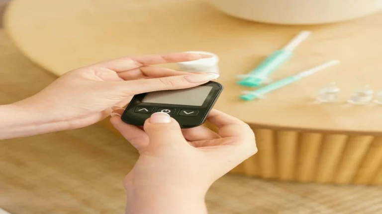 Person checking blood sugar level with glucometer showing normal HbA1c concept
