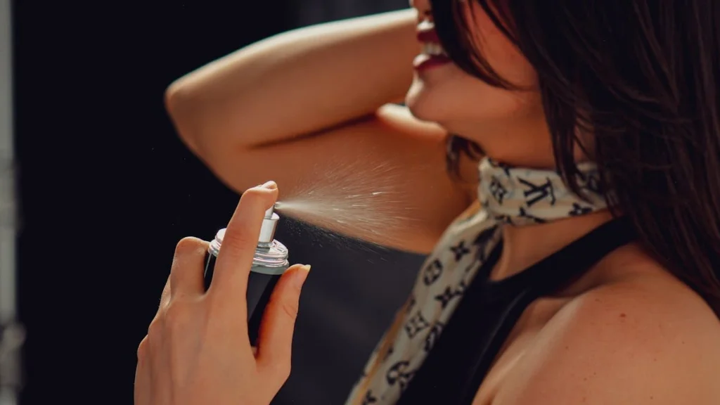 Woman applying perfume highlighting potential hormone disruption effects