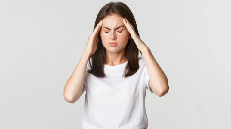 Person experiencing headache behind the eyes and facial pressure, commonly associated with migraine, sinus congestion, or eye strain.