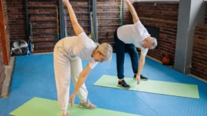 Active senior performing a plyometric step-up exercise to improve muscle power, balance, and bone strength for healthy aging.