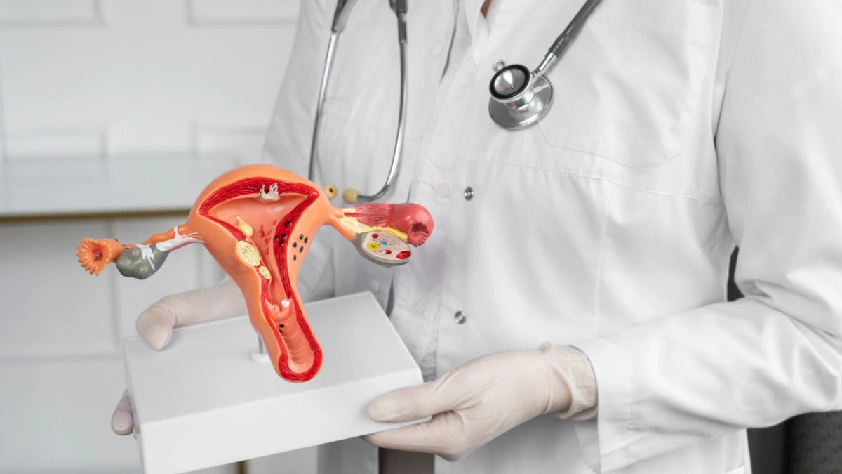 Woman experiencing stress and pelvic discomfort, illustrating the potential connection between chronic stress, cortisol, and uterine fibroids.