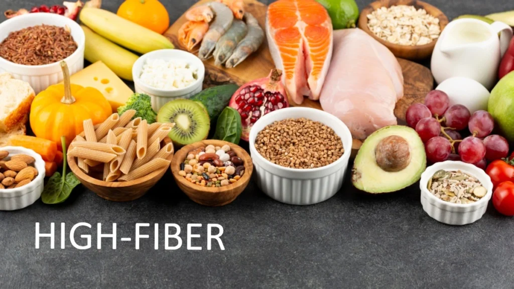A healthy selection of high fiber foods including lentils, chickpeas, oats, broccoli, apples, and whole grains for diabetes and blood sugar control.
