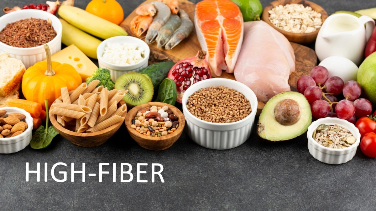 A healthy selection of high fiber foods including lentils, chickpeas, oats, broccoli, apples, and whole grains for diabetes and blood sugar control.
