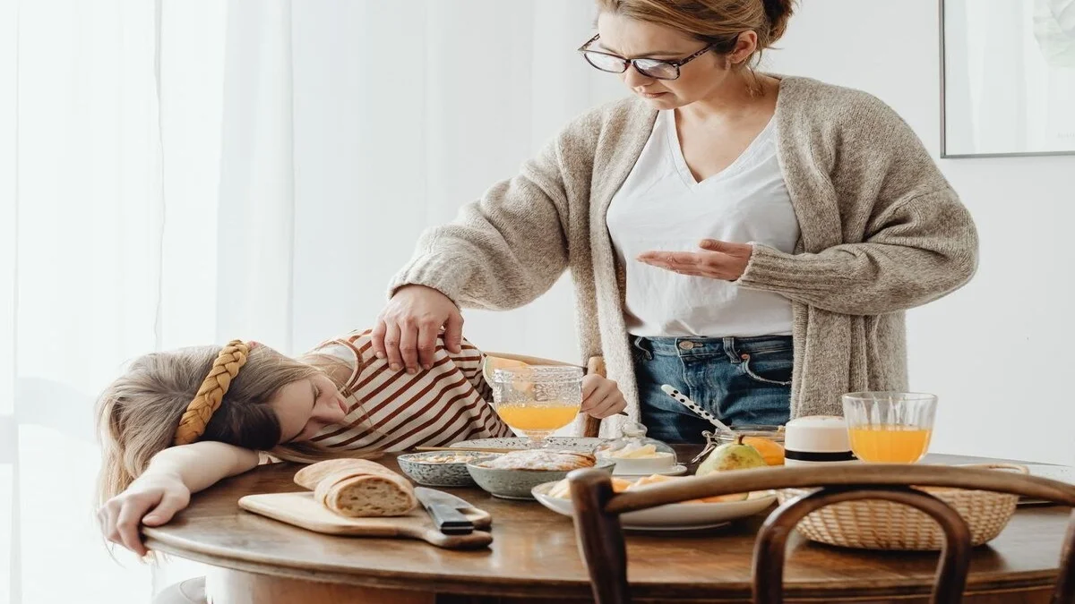 Woman feeling sleepy and tired after eating breakfast, experiencing post-meal fatigue and low energy after a meal