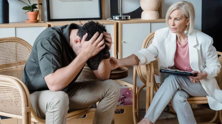 Patient receiving transcranial magnetic stimulation (TMS) therapy for depression with a magnetic coil positioned on the scalp during a non-invasive brain stimulation session