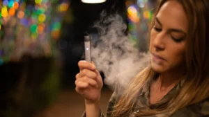 Cigarette and vape device placed side by side showing the comparison between smoking and vaping risks