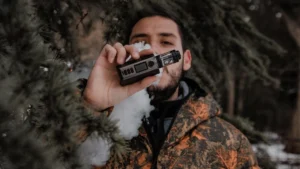 Person holding a disposable vape with a brain illustration showing dopamine pathways, representing how nicotine rapidly affects the brain and causes addiction.