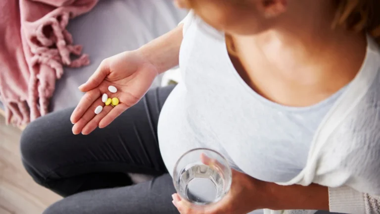 Pregnant woman discussing mental health medication safety with a healthcare professional