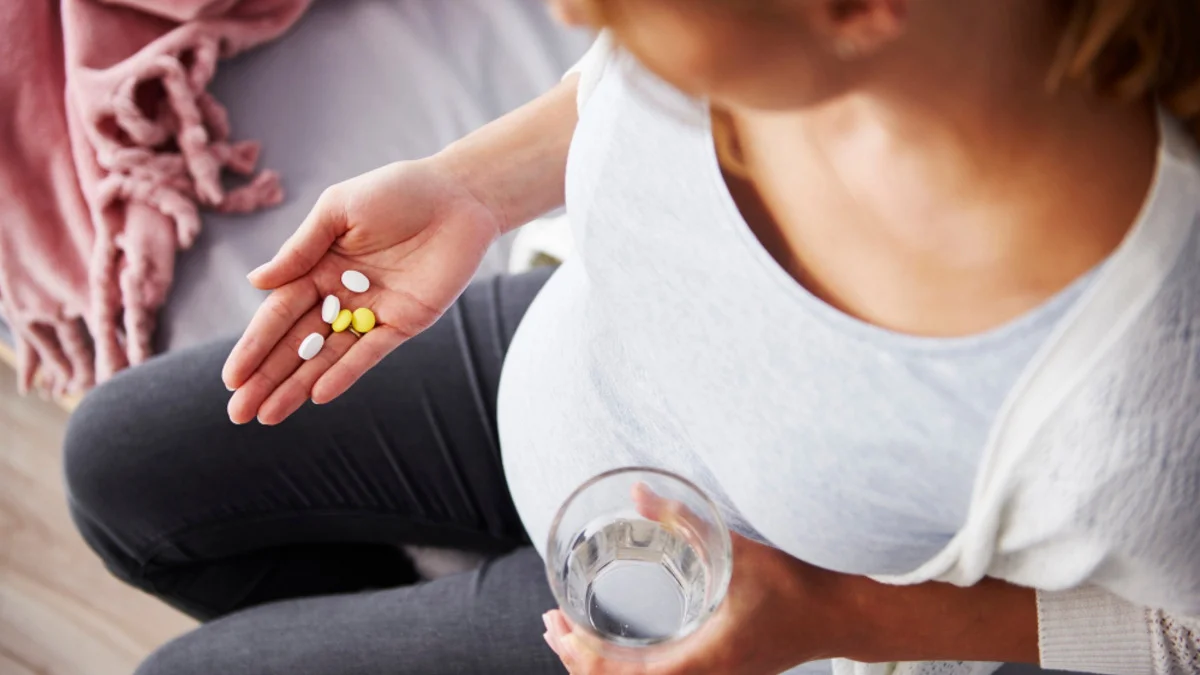 Pregnant woman discussing mental health medication safety with a healthcare professional