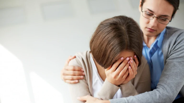 Therapist providing PTSD treatment support through trauma-focused psychotherapy session